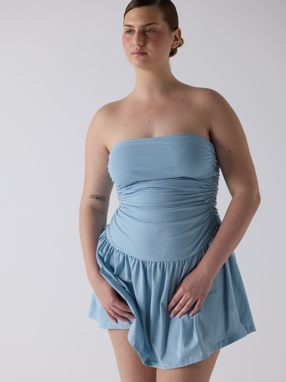 kim wears the twist dress in blue micro stripe, fit 3