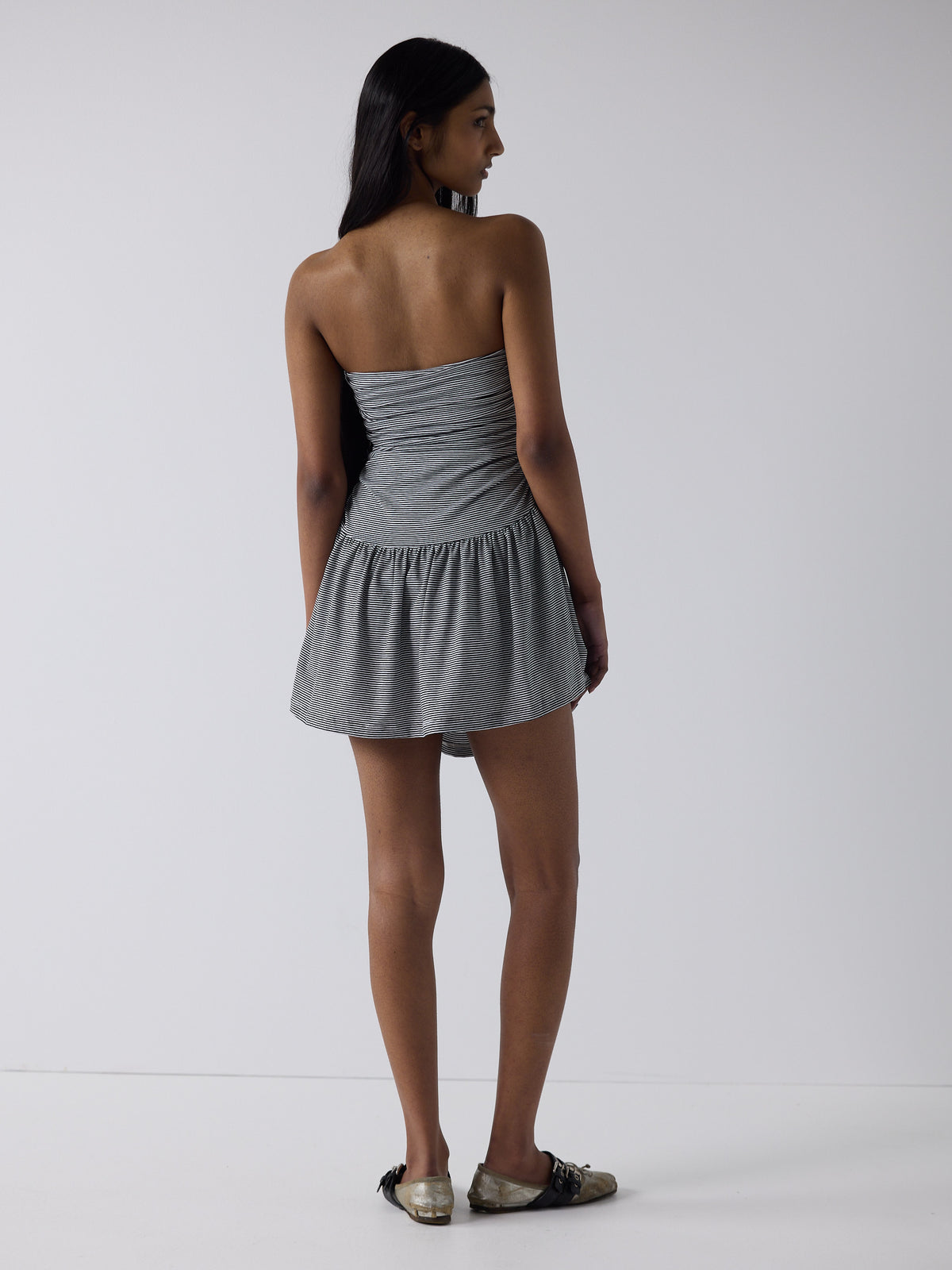 haasi wears the twist dress in black micro stripe, fit 1