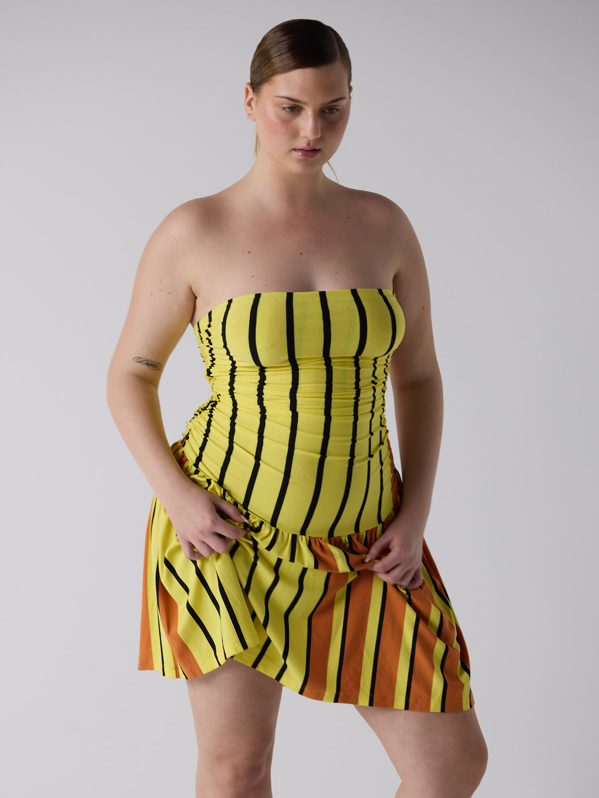 kim wears the twist dress in candy corn, fit 3