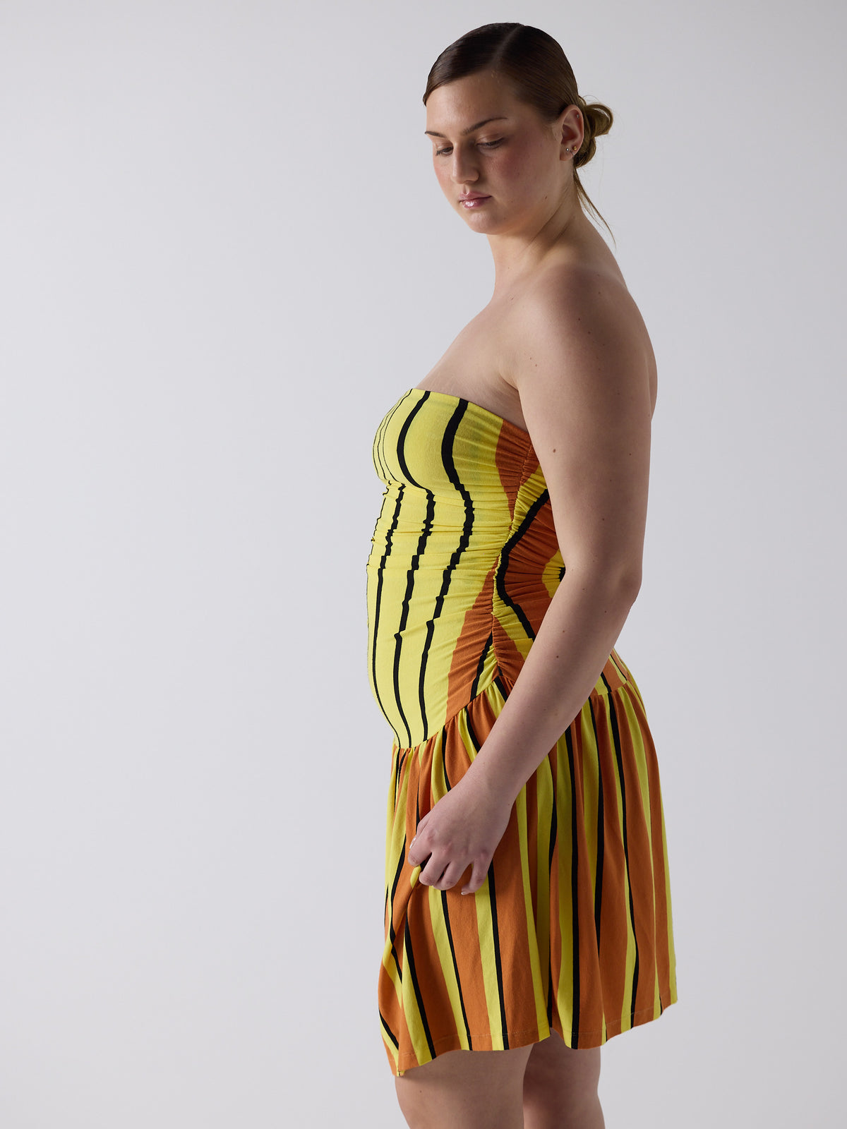 kim wears the twist dress in candy corn, fit 3