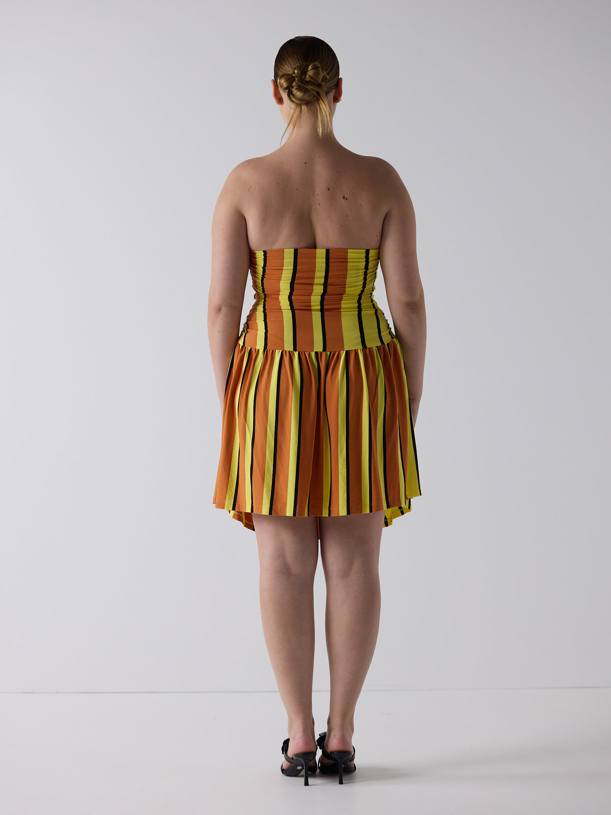 kim wears the twist dress in candy corn, fit 3