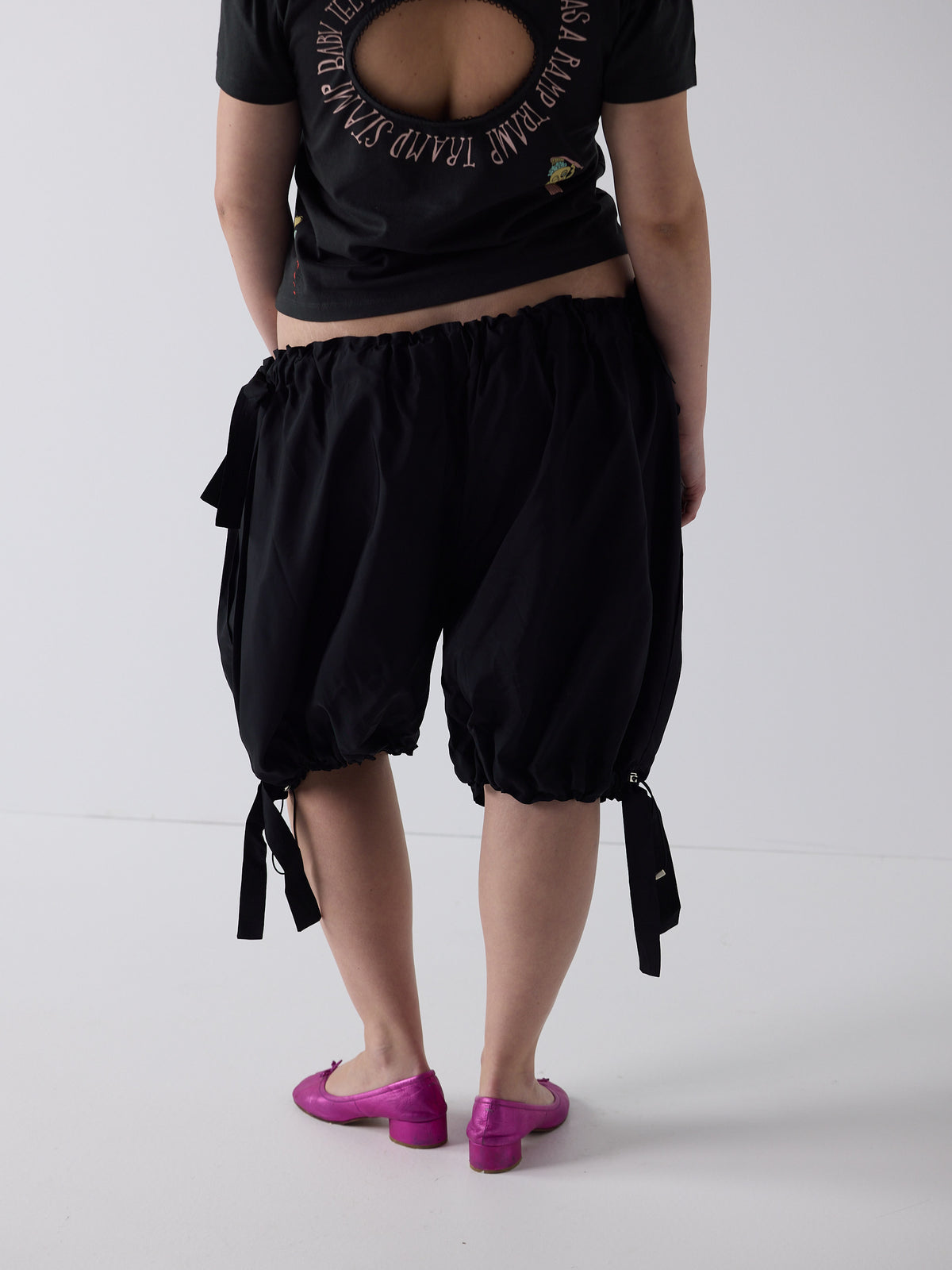 kim wears the logo removal baby tee in cutie charcoal, size 2xl