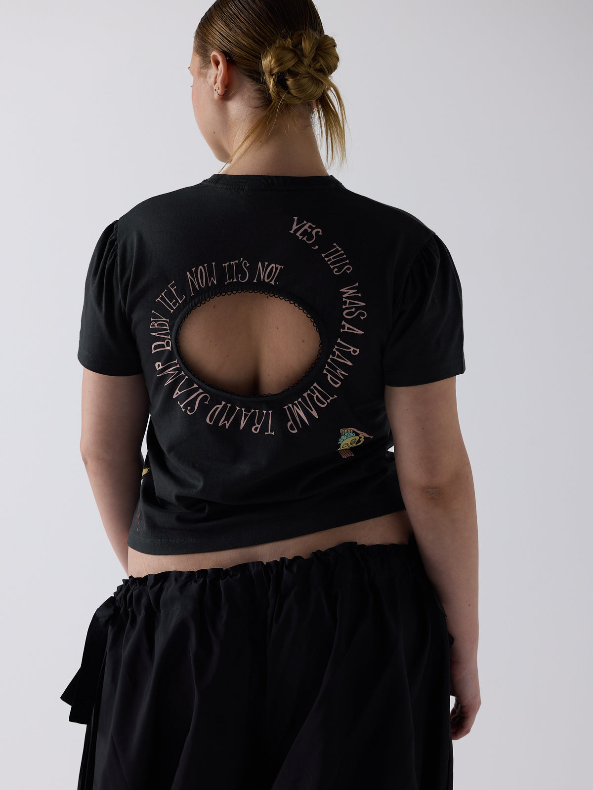 kim wears the logo removal baby tee in cutie charcoal, size 2xl