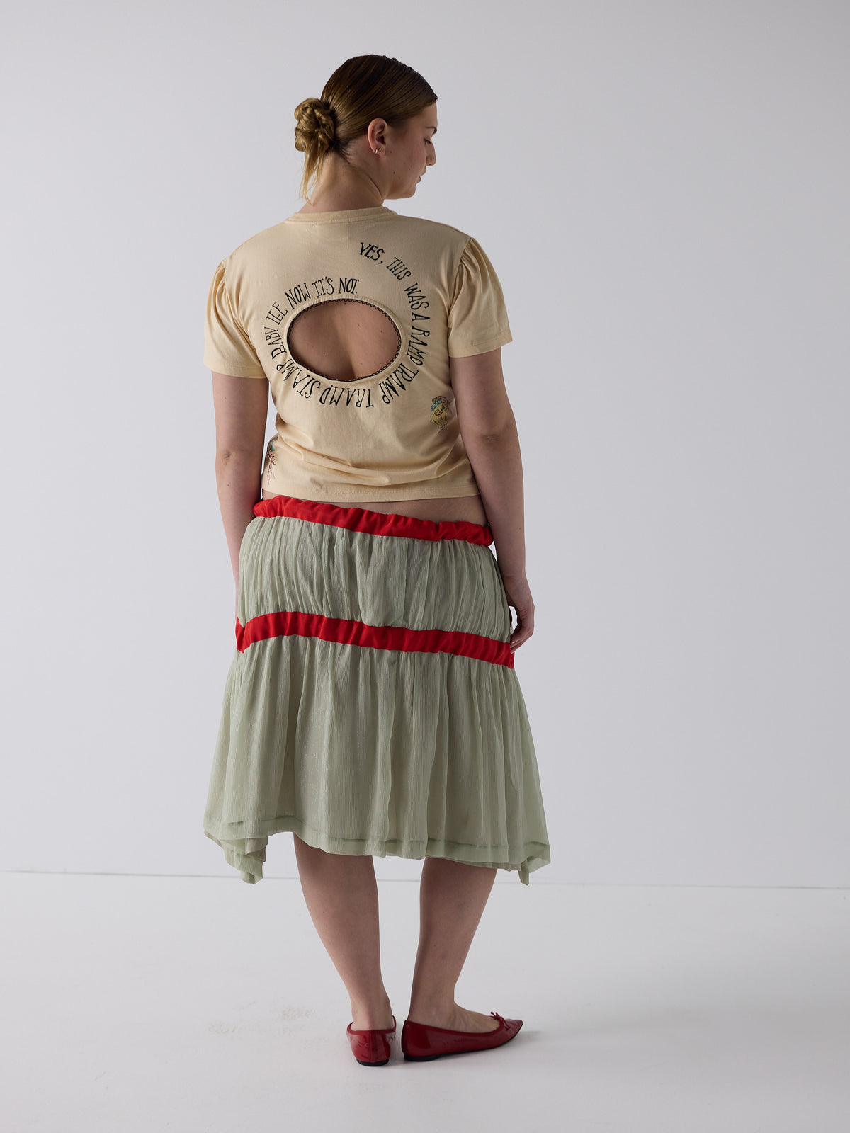kim wears the logo removal baby tee in cutie creme fraiche, size 2xl