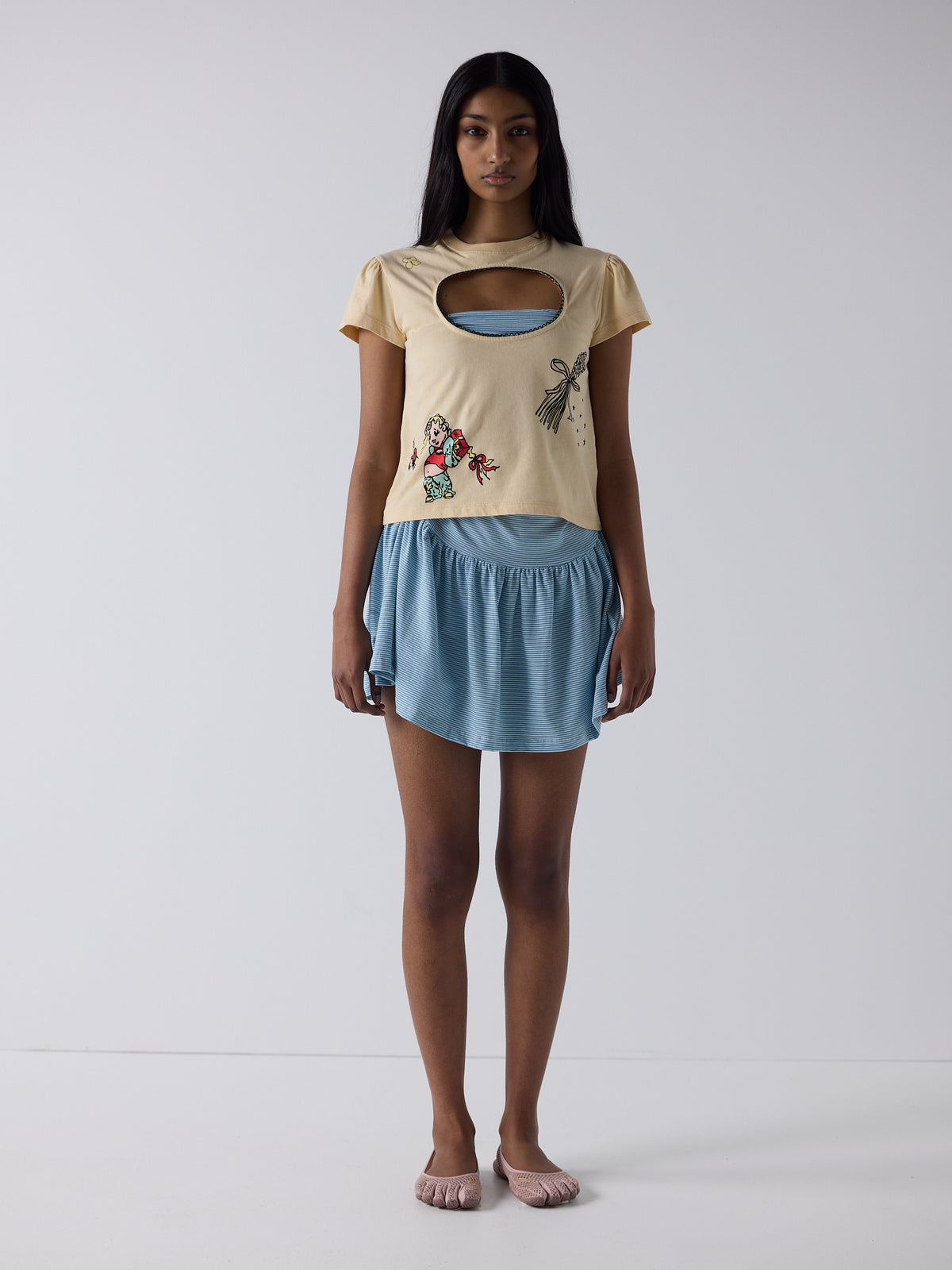 haasi wears the logo removal baby tee in cutie creme fraiche, size m