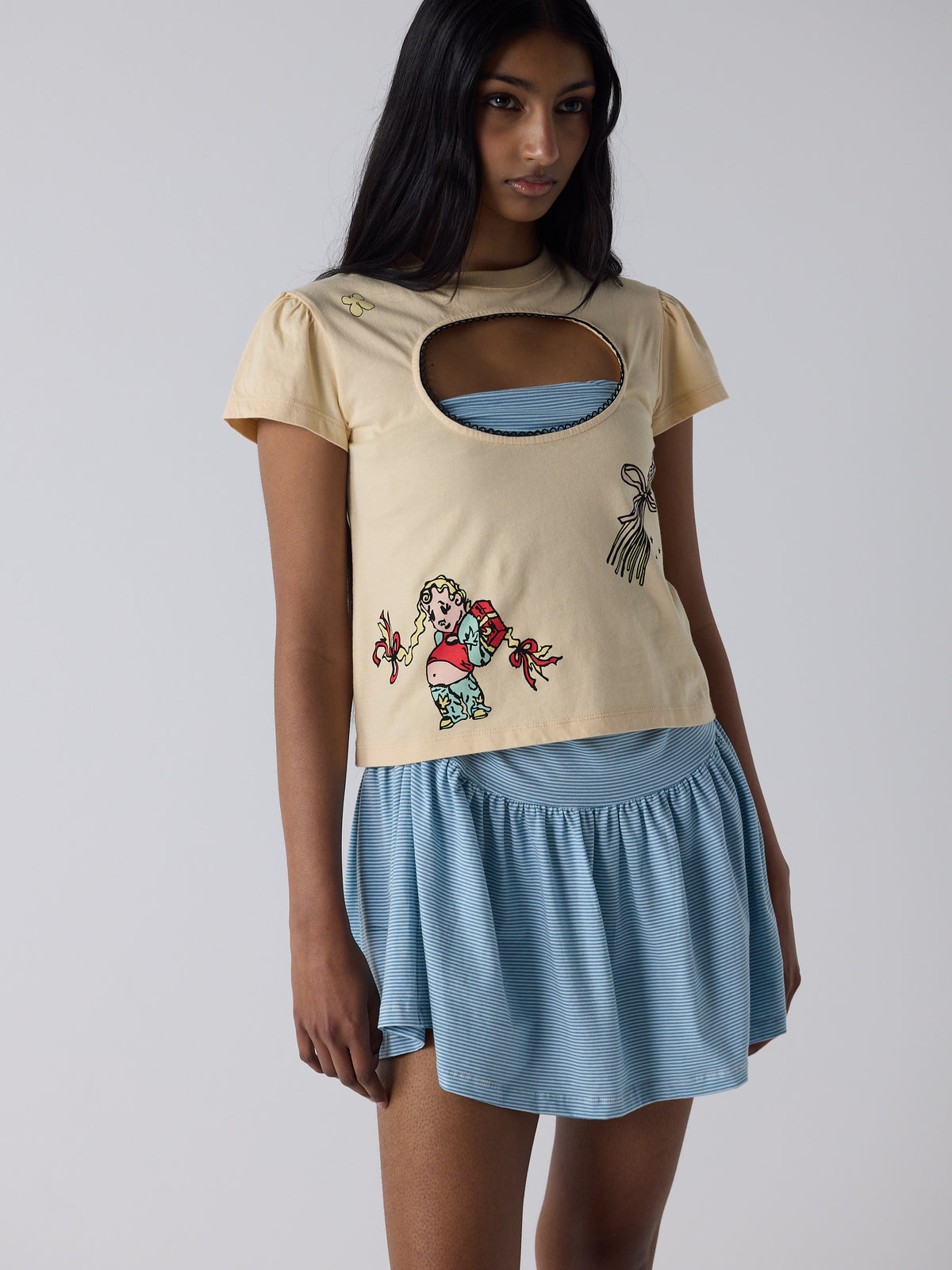 haasi wears the logo removal baby tee in cutie creme fraiche, size m