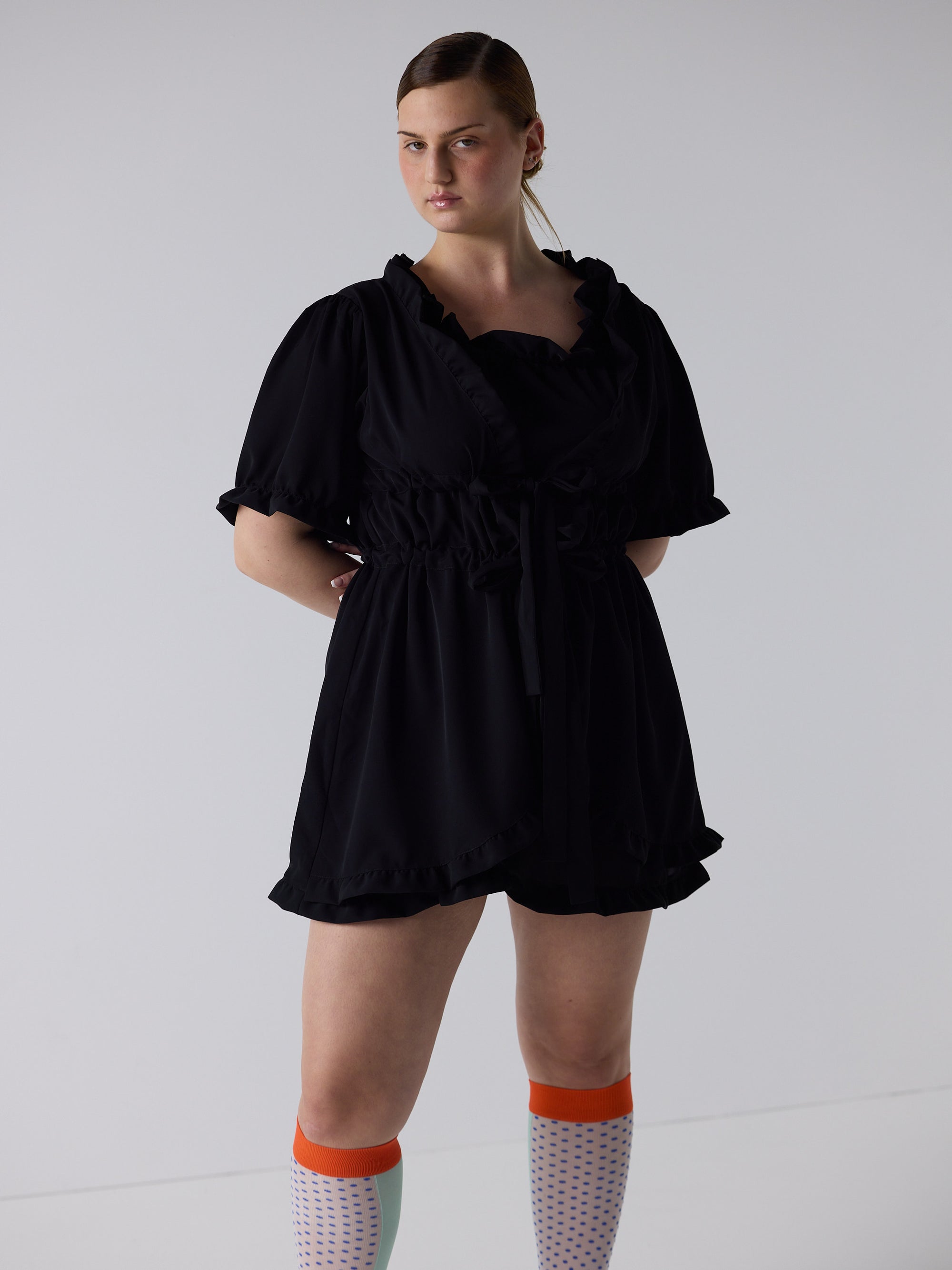 kim wears the babydoll dress in black, fit 2