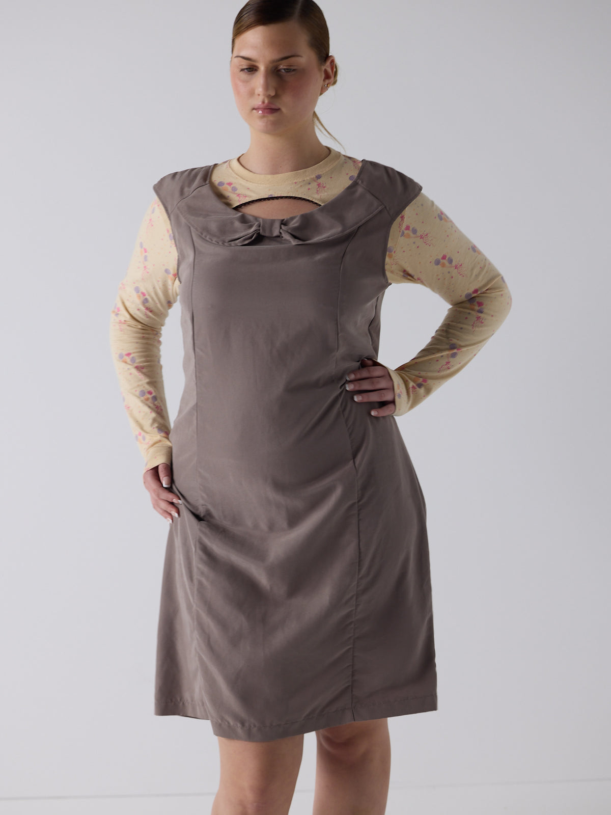 kim wears the office bow dress in fawn