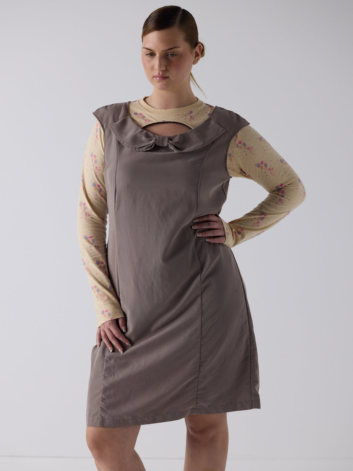 kim wears the office bow dress in fawn