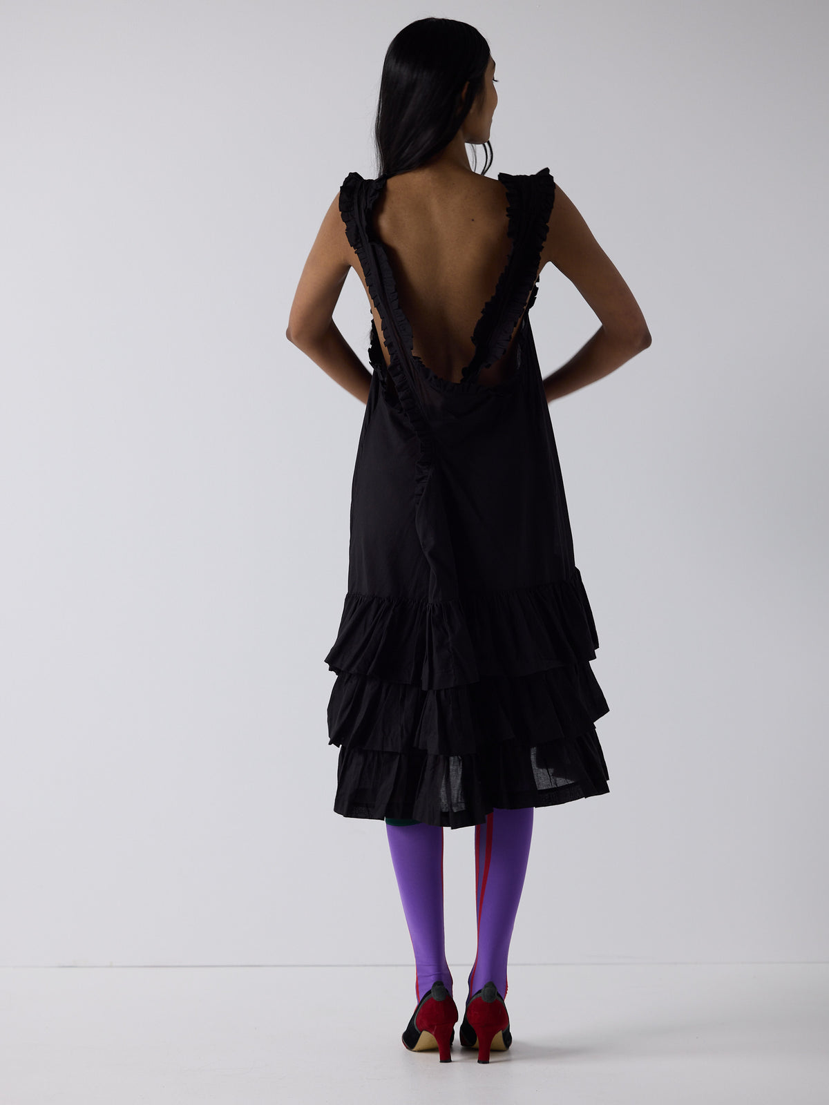 haasi wears the apron frill drop waist dress in black