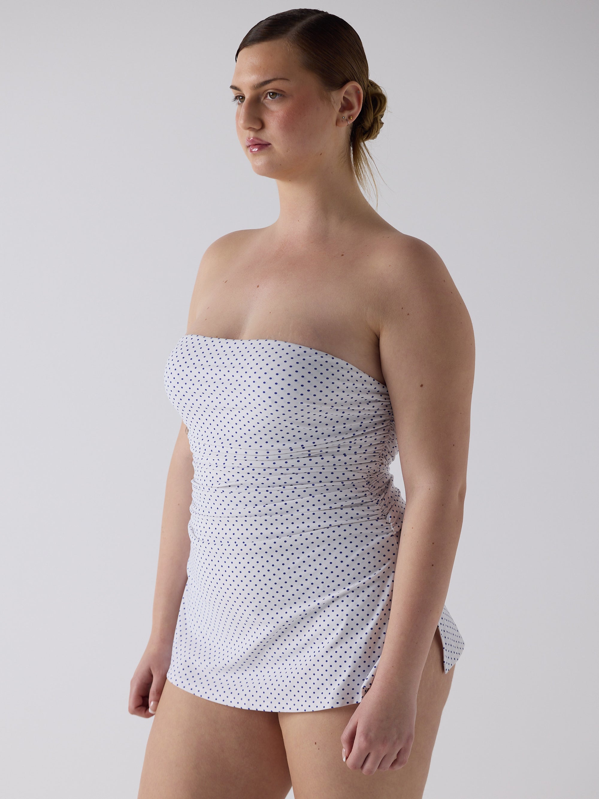 kim wears the twist one piece in blue micro dot, size l