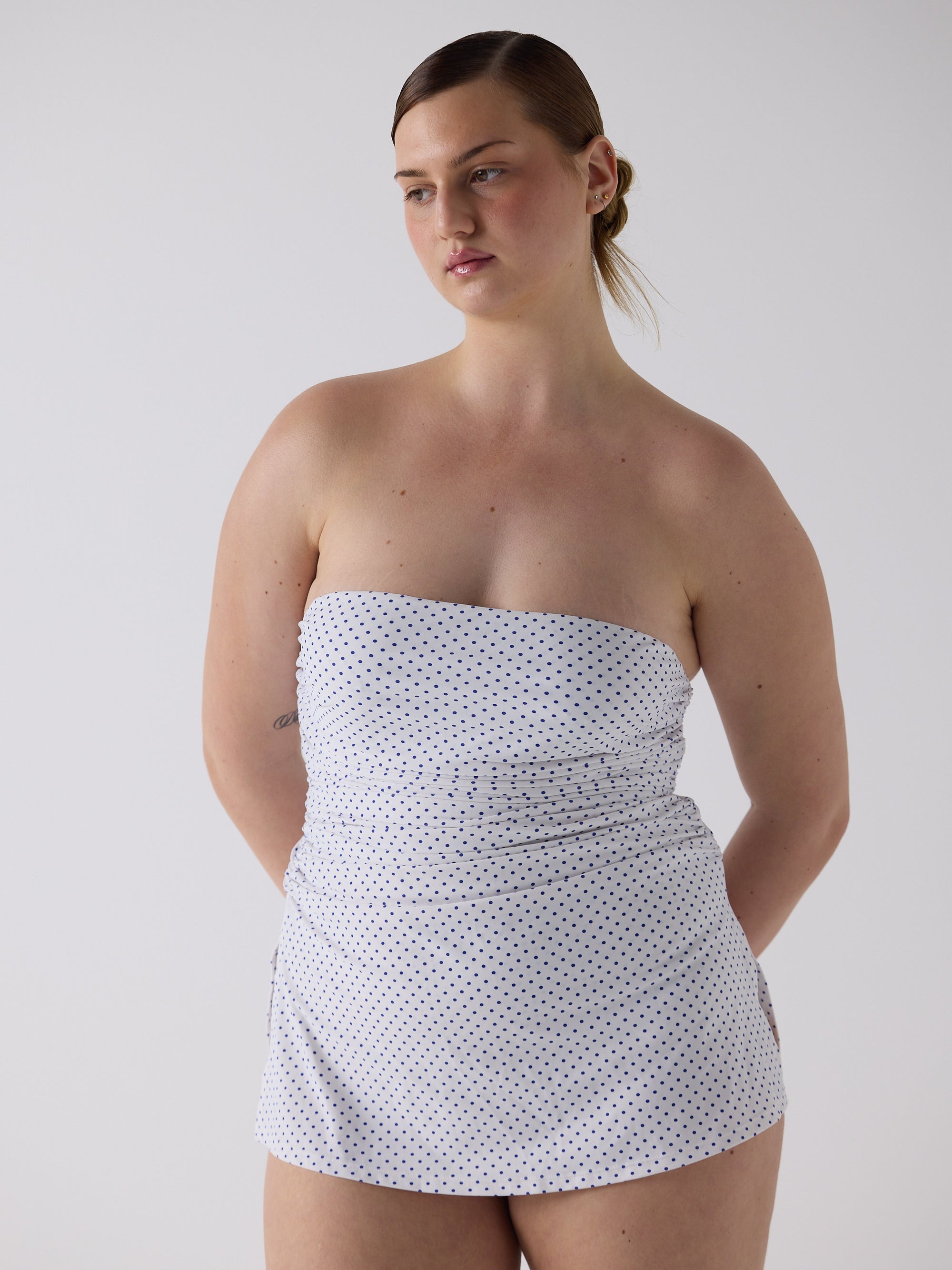 kim wears the twist one piece in blue micro dot, size l