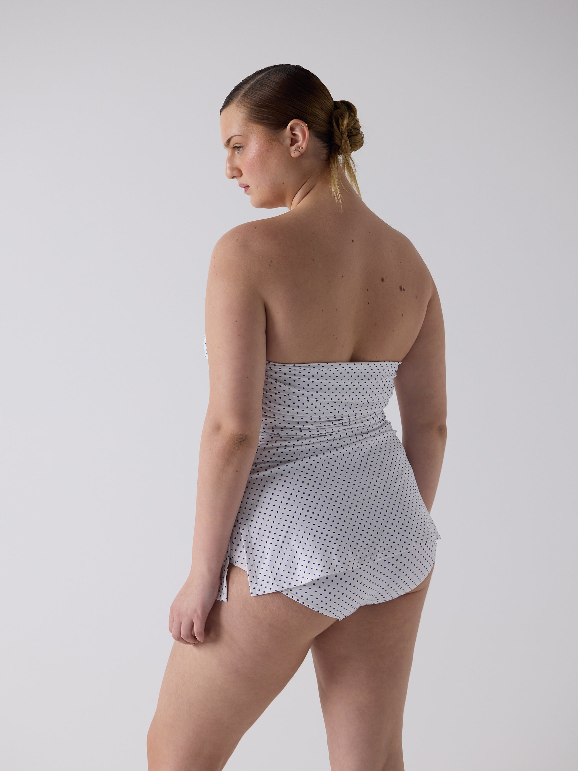kim wears the twist one piece in blue micro dot, size l