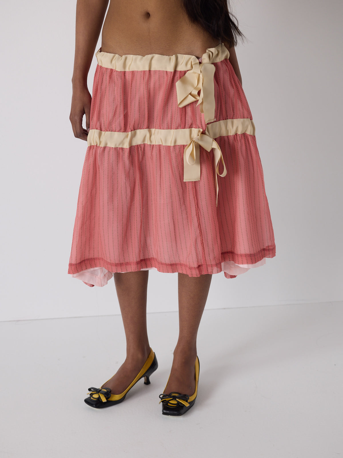 haasi wears the drop waist tiered skirt in flesh, fit 1