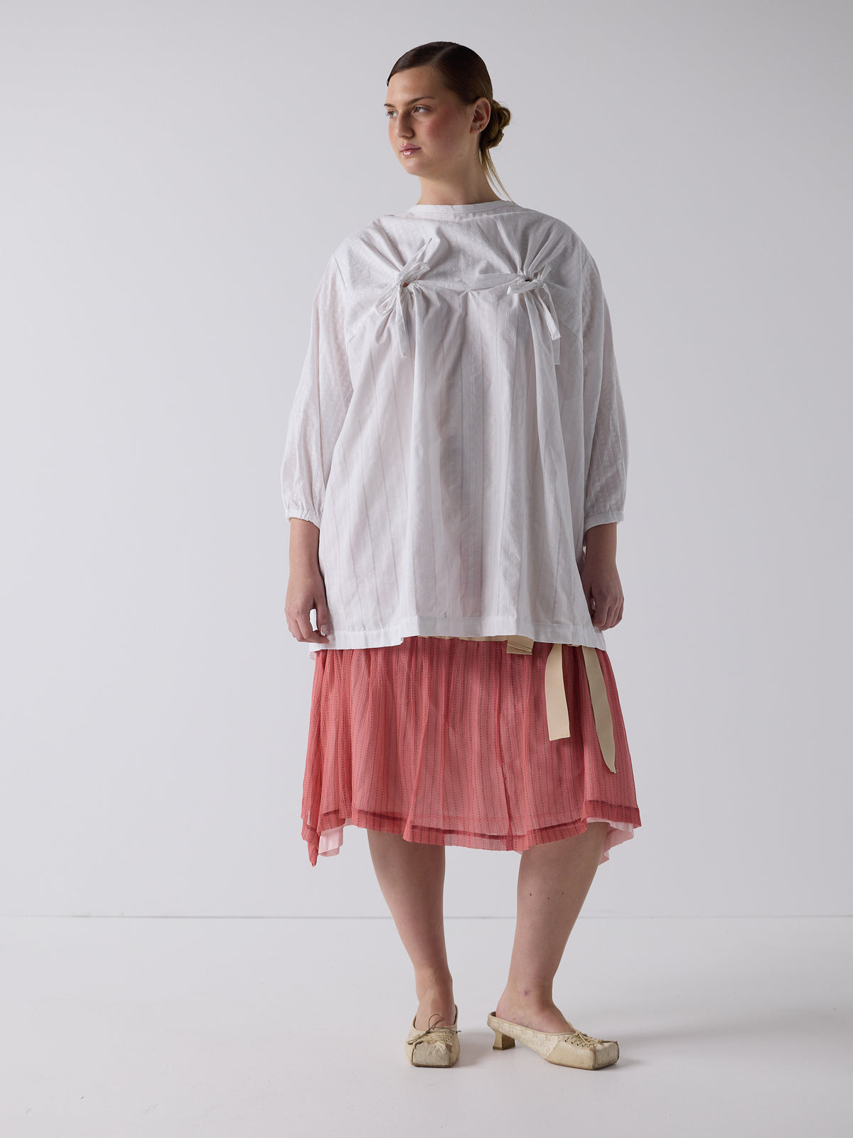 kim wears the drop waist tiered skirt in flesh, fit 2