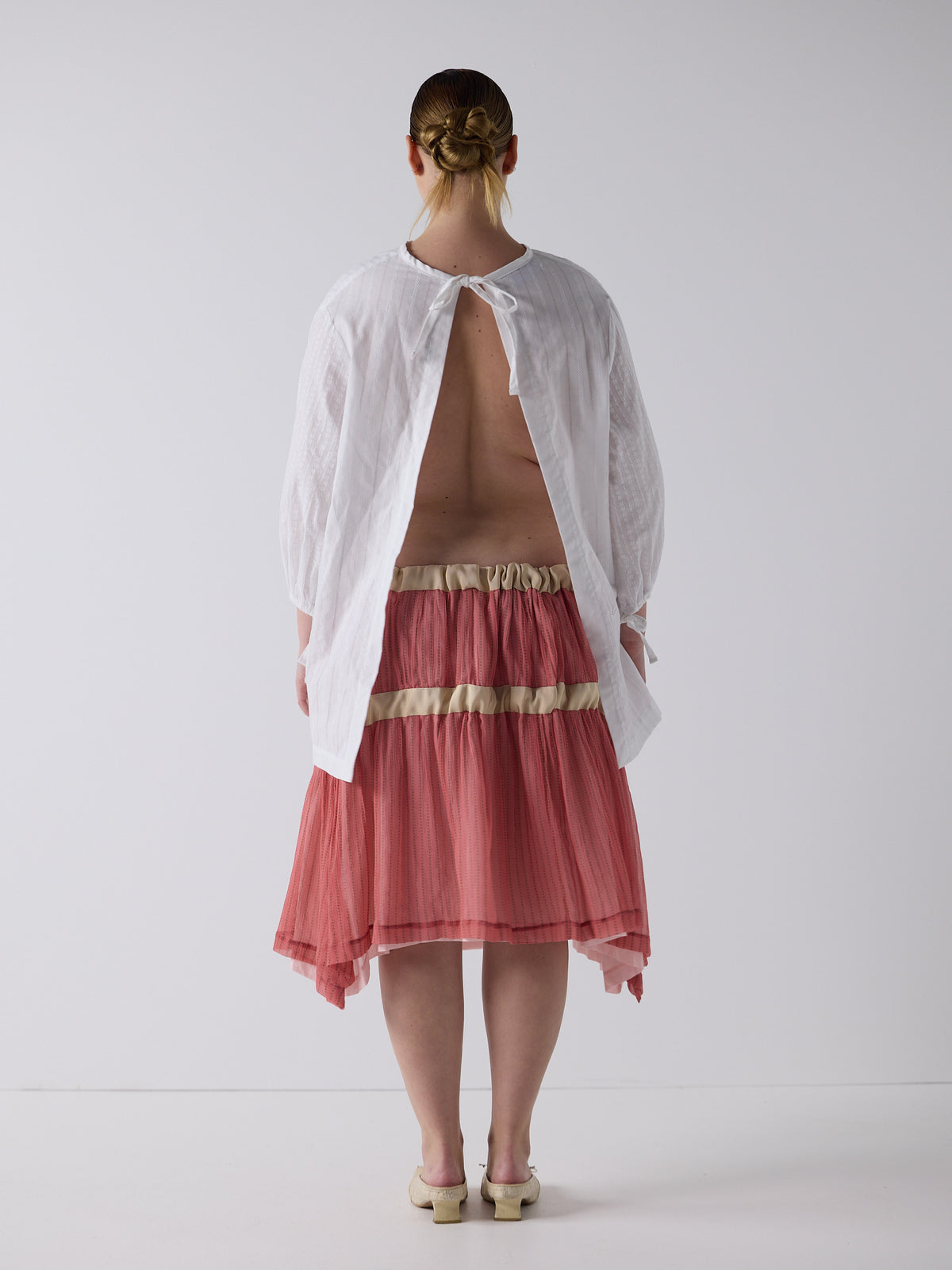 kim wears the drop waist tiered skirt in flesh, fit 2