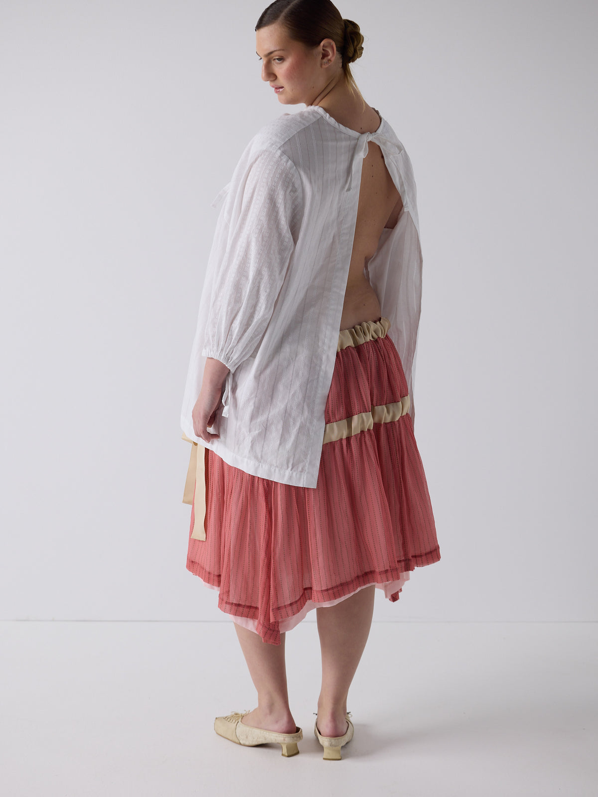 kim wears the drop waist tiered skirt in flesh, fit 2