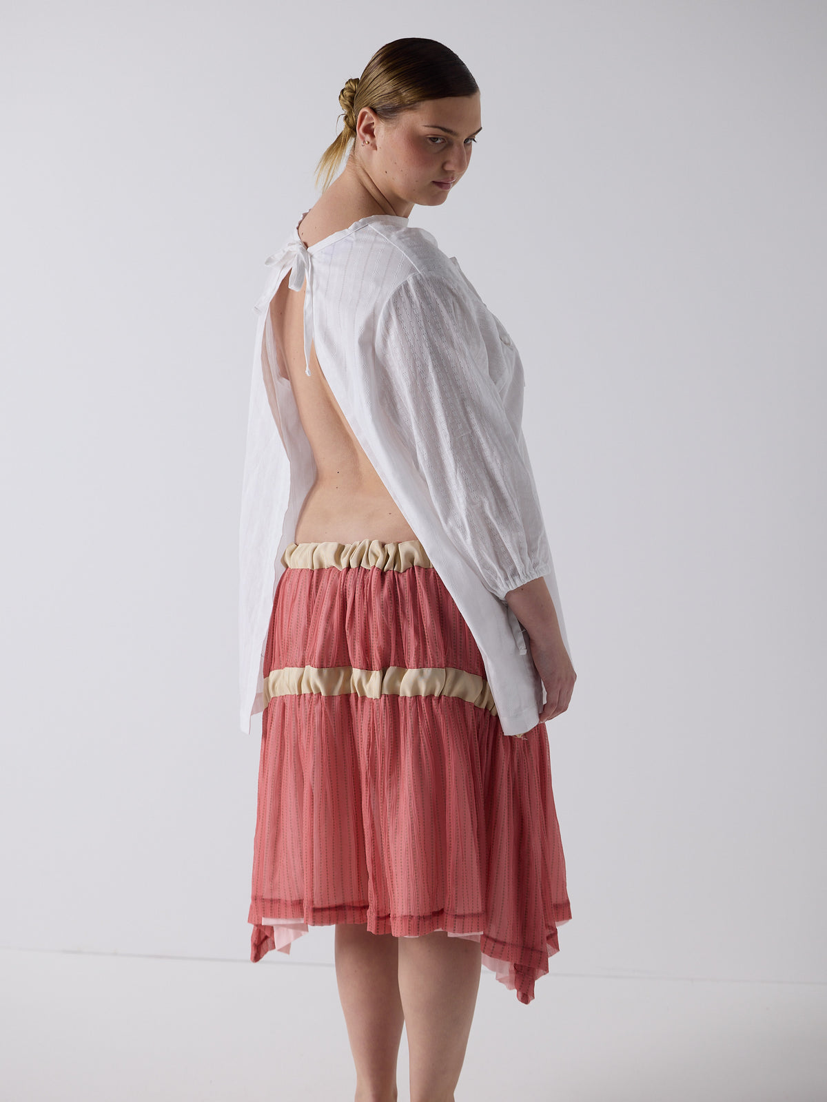 kim wears the drop waist tiered skirt in flesh, fit 2