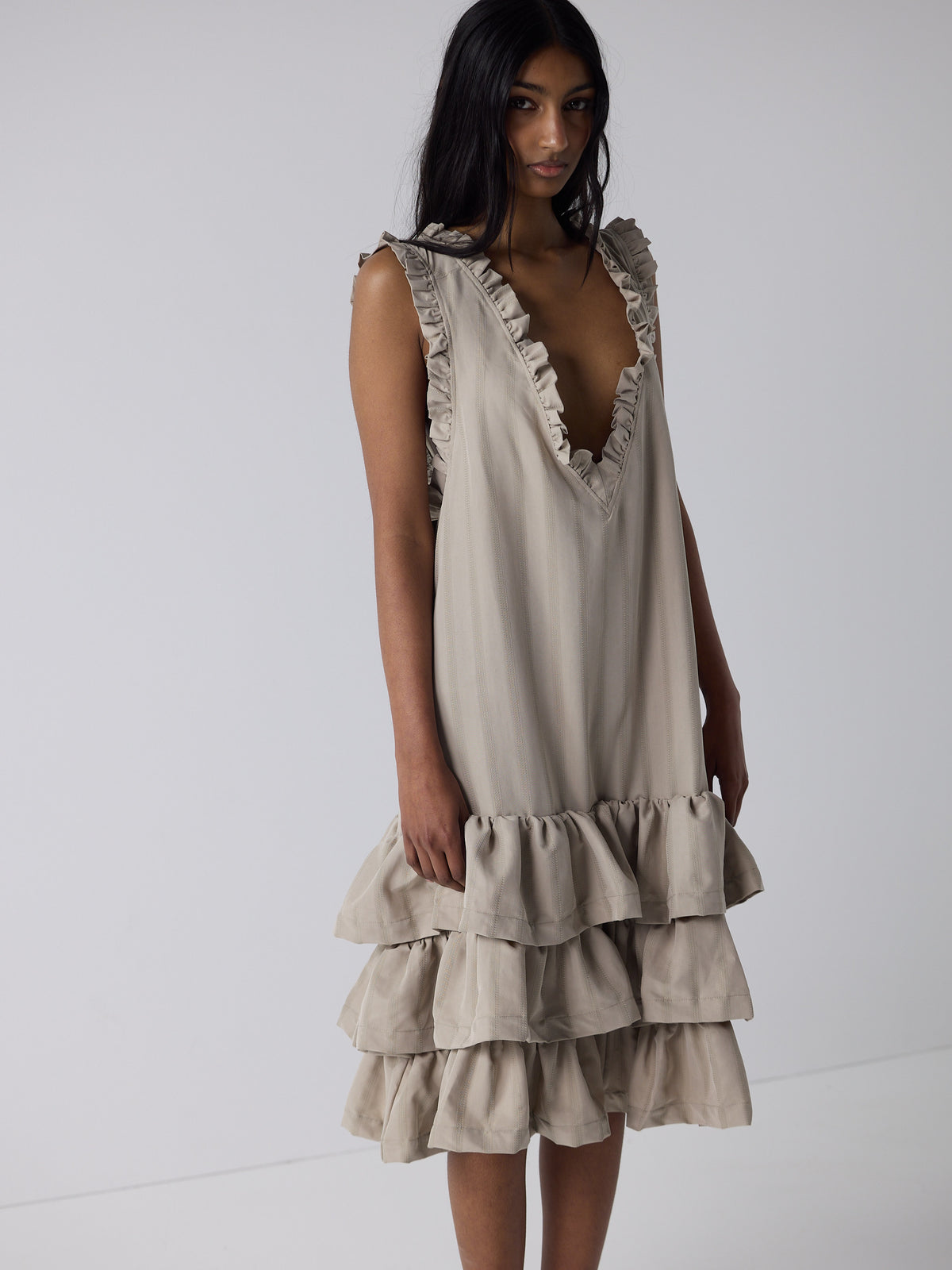 haasi wears the tiered drop waist dress in sandstone
