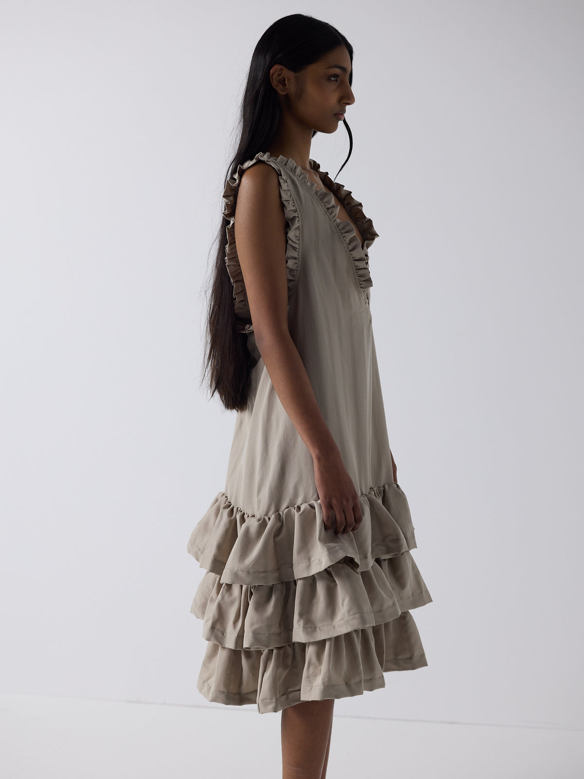 haasi wears the tiered drop waist dress in sandstone