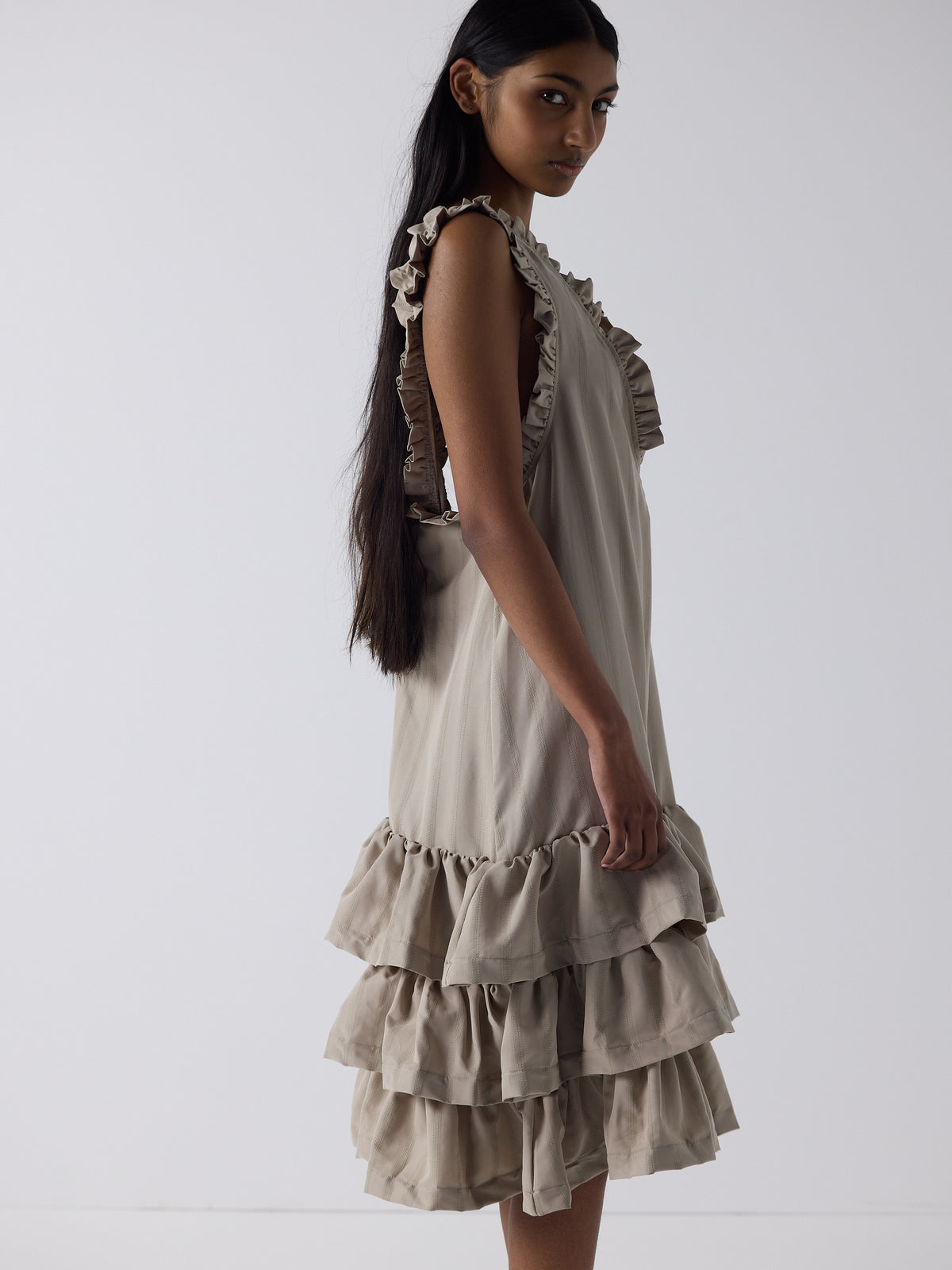 haasi wears the tiered drop waist dress in sandstone