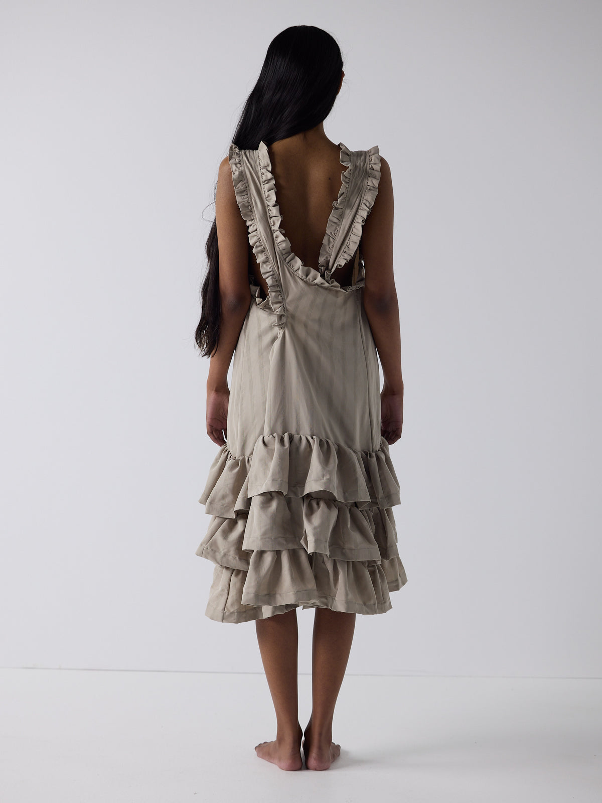 haasi wears the tiered drop waist dress in sandstone