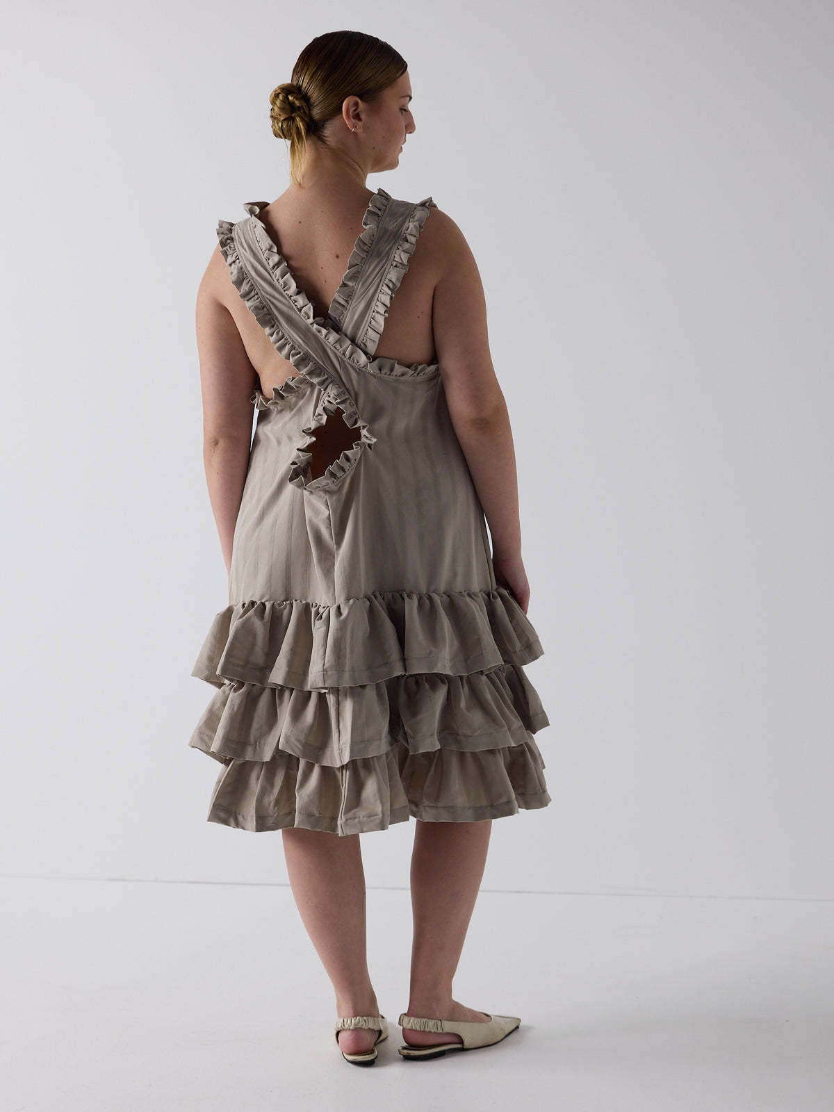 kim wears the tiered drop waist dress in sandstone